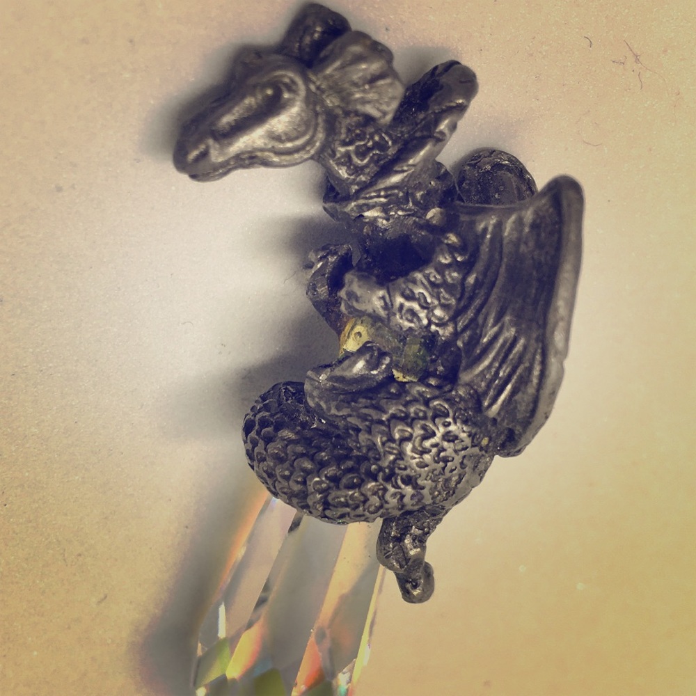 Metal dragon and crystal point pendent.